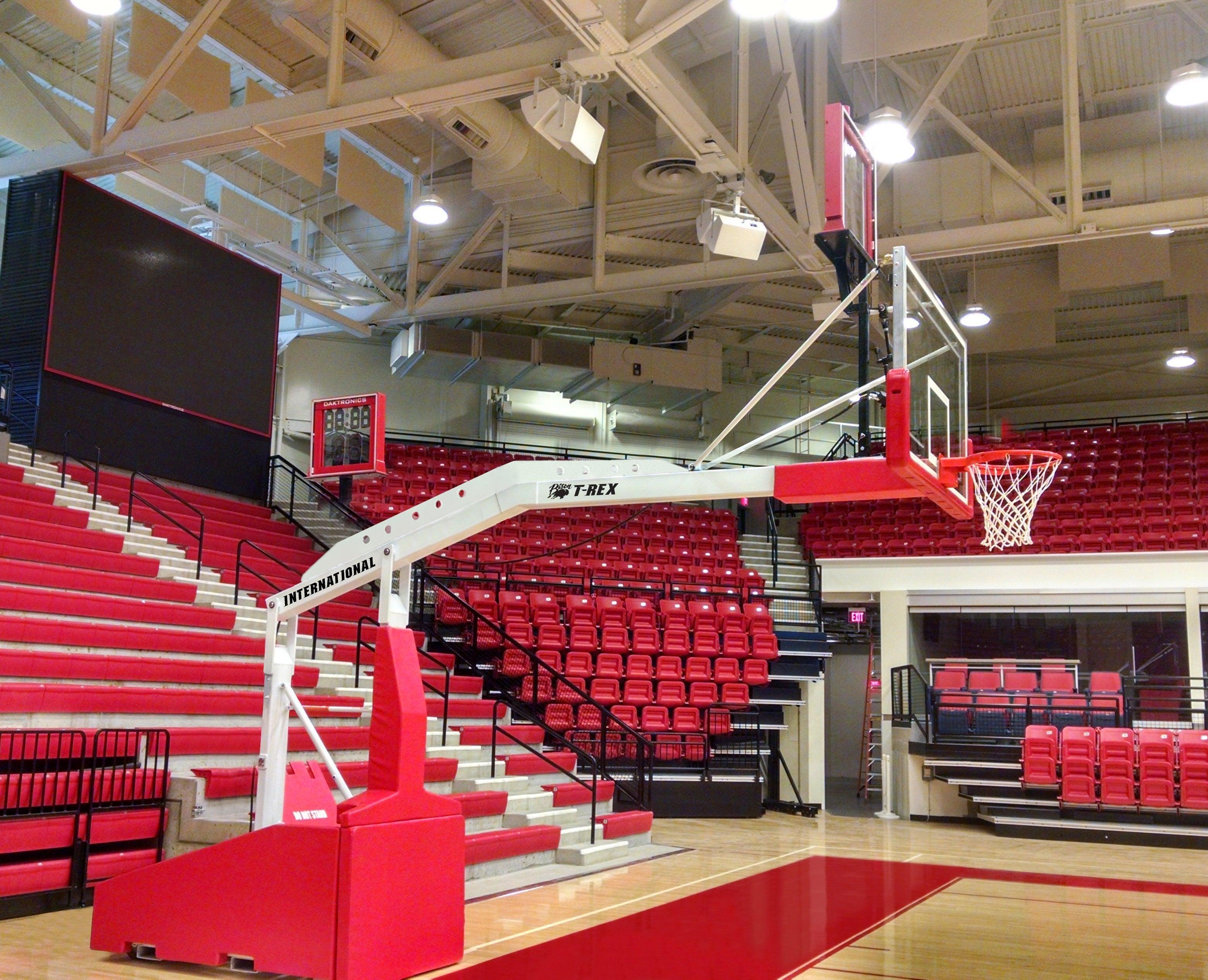 Bison T-REX International automatic portable basketball system shown on competition gym floor